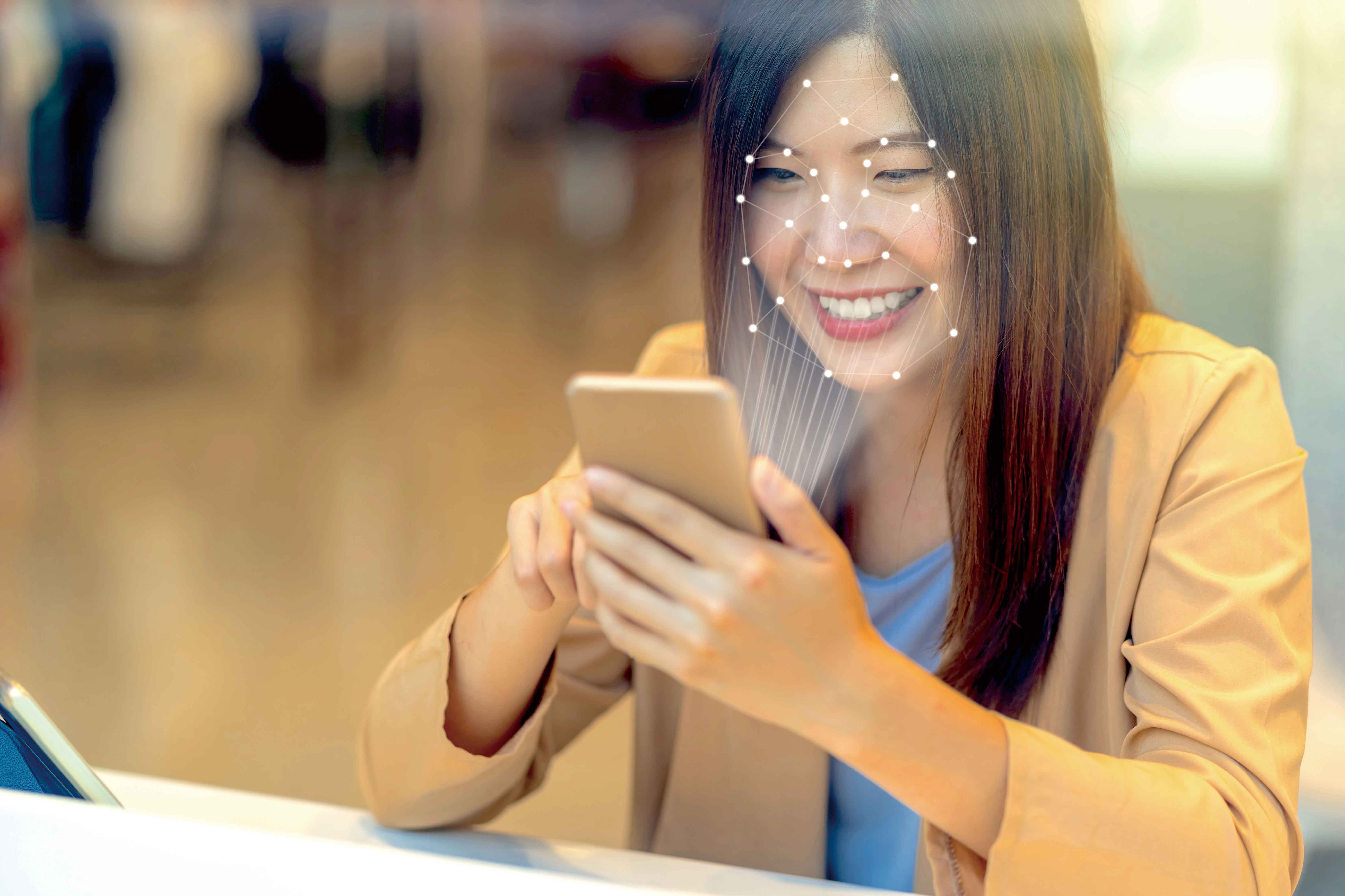 asian-women-using-the-technology-tablet-for-access-39XHR9P